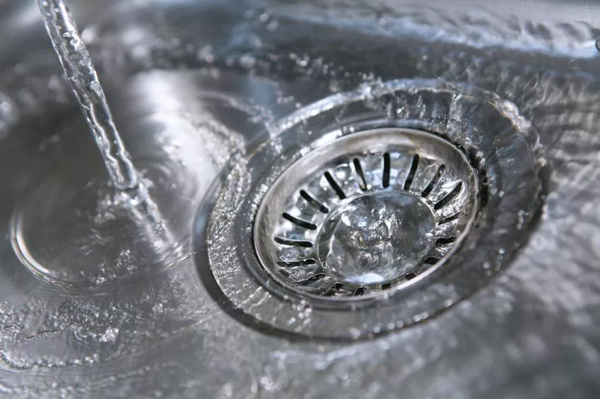 Image of a water heater and professional installer Albuquerque