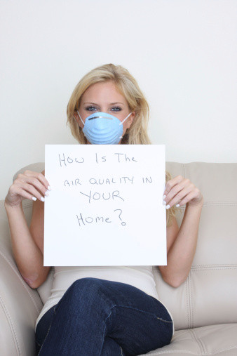 Image of woman in a mask with air quality sign