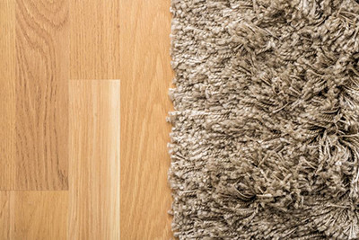 Image of carpet and hard wood flooring side by side