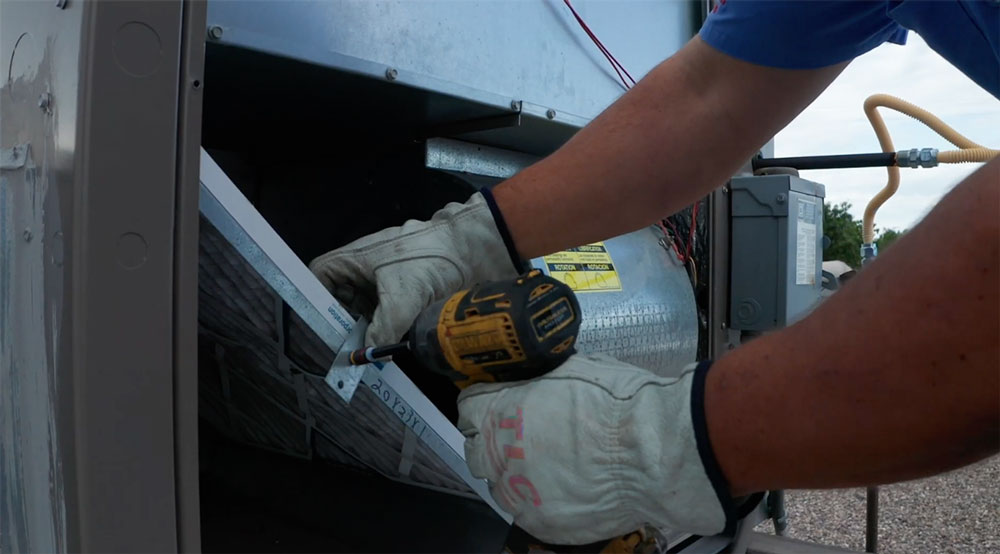 Image showing a guy changing a commercial air filter