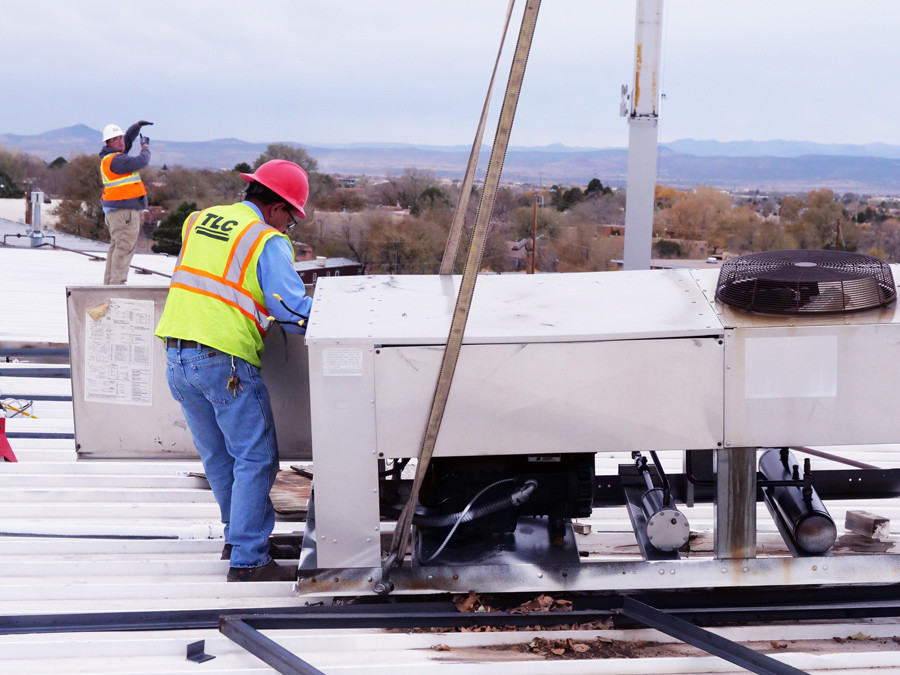 Image of men installing commercial air conditoner