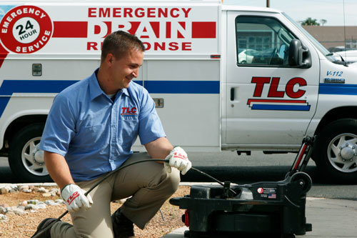 Image of a TCL employee performing emergency drain services