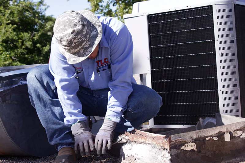 TLC-Technician-Fixing-AC-Unit-on-roof-in-Albuquerque