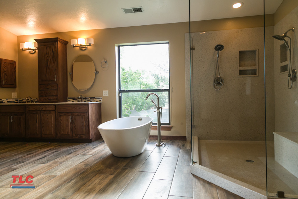 custom bathroom remodel with wood tile and free standing tub