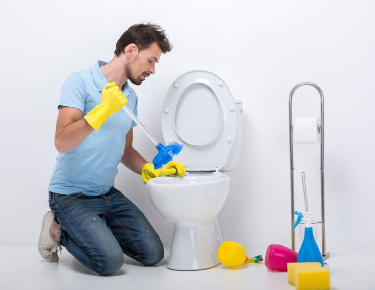 Image of a guy about to plunge a toilet