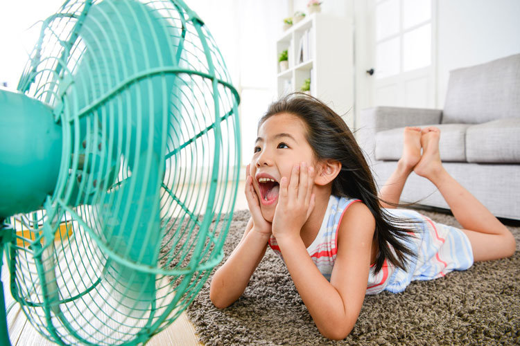 Image of a girl laying in front of a fan
