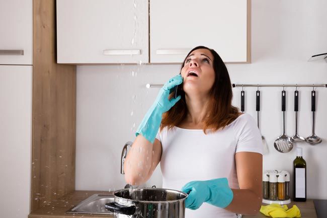 Image of a woman trying to catch water in a pot