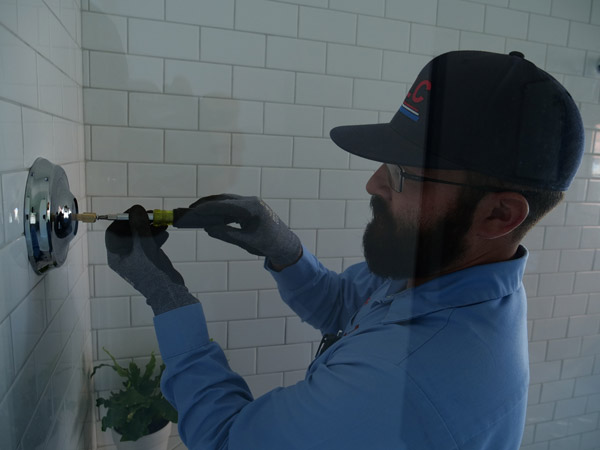 Image of a TLC contractor working on a shower