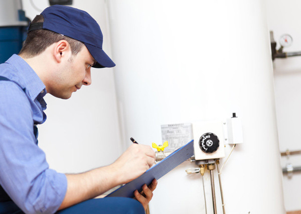Image of a man checking a water heater