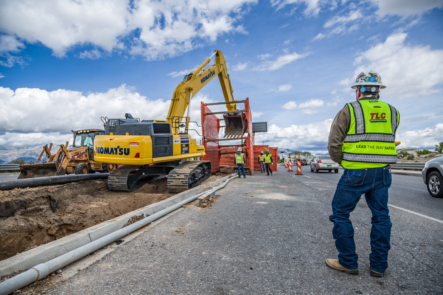 Image of a professional plumber with a thumbs up in front of a water heater